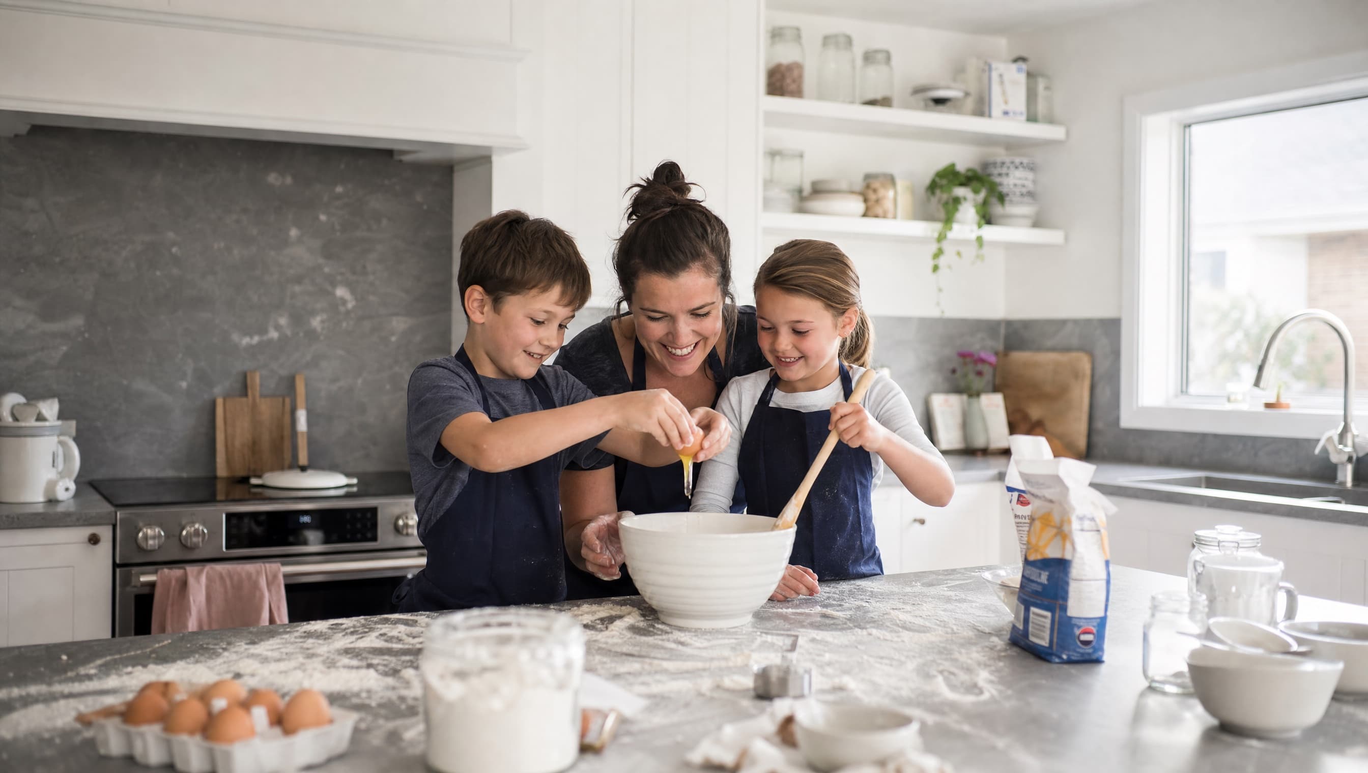 A mum and two kids baking together at the kitchen bench
